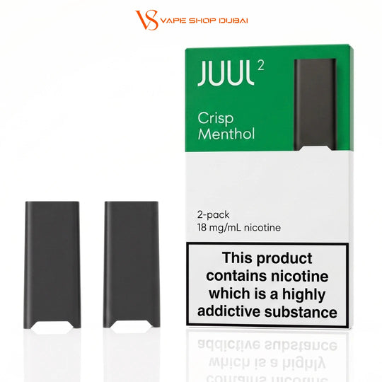 Two JUUL 2 disposable vape pods shown next to their original packaging box on a white background. The packaging is green and white with a prominent nicotine warning label.