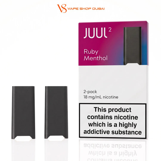 Two black JUUL 2 disposable vape devices shown next to their retail packaging on a white background. The packaging is white with a purple-to-blue gradient top section, labeled 'JUUL 2 Ruby Menthol', and includes a prominent nicotine warning label.