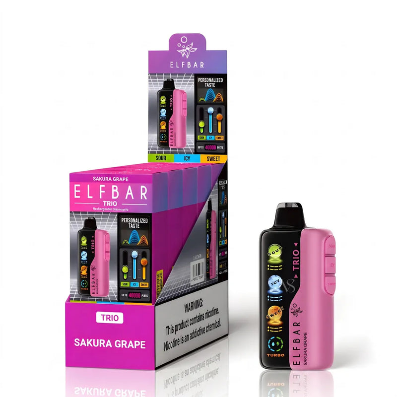 A pink and black ELFBAR disposable vape device stands next to its retail display box. The packaging is primarily pink and purple with graphics of the Sakura Grape flavor, and the device itself features colorful cartoon character illustrations on the front.