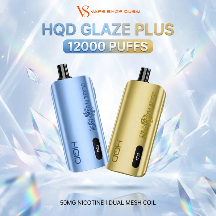 Two vape devices, one in light blue and one in metallic gold, labeled 'HQD GLAZE PLUS' and '12000 PUFFS', shown against a icy crystal background with 'VS Vape Shop Dubai' branding and '50MG NICOTINE | DUAL MESH COIL' text.
