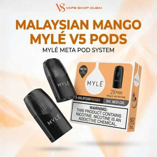 Two black MYLÉ V5 pod vape devices and their retail box for Malaysian Mango flavor, displayed on a light cream background with orange and black text. The MYLÉ brand is visible on the pods and packaging.