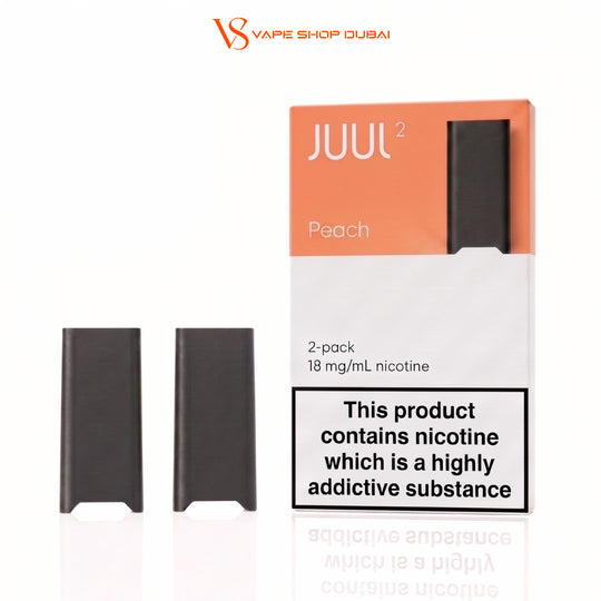 Two black JUUL 2 disposable vape devices shown next to their original packaging box on a white background. The packaging is peach and white with a prominent nicotine warning label.
