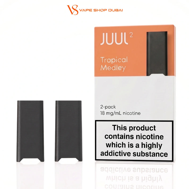 Juul 2 Tropical Medley 2-pack disposable vape pods with their original packaging box on a white background. The box is orange and white with a black warning label, and two black vape pods are displayed next to it.