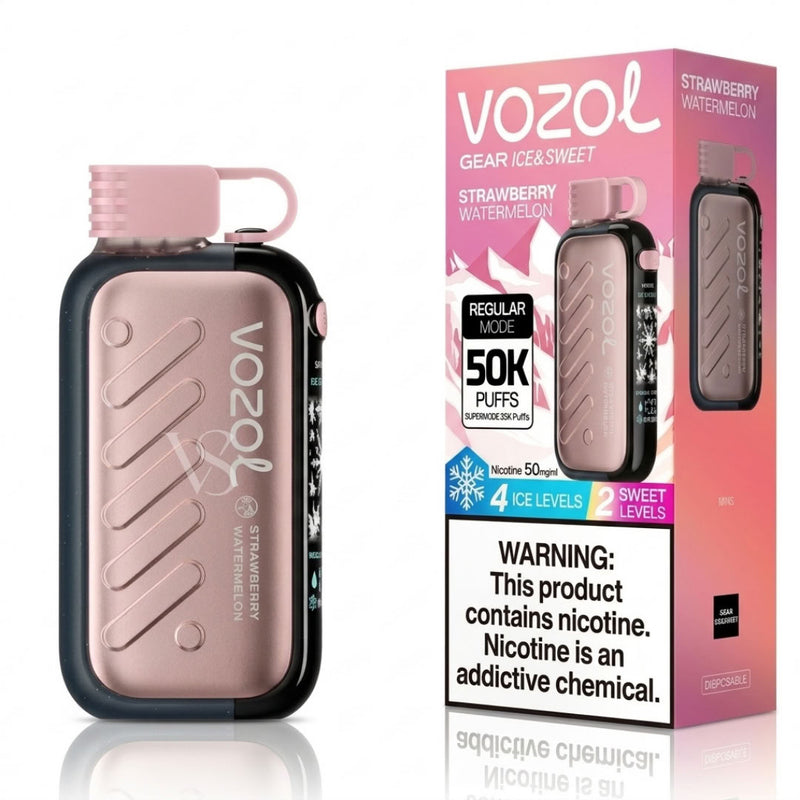 Vozol Strawberry Watermelon disposable vape device next to its retail packaging box, featuring a metallic rose gold body with a black base and a pink mouthpiece.