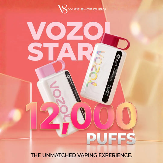 Promotional graphic for Vozol Stars disposable vapes by Vape Shop Dubai, showing two white vapes with pink and red caps against a warm pink and orange gradient background with large text reading 'VOZOL STARS' and '12,000 PUFFS'.